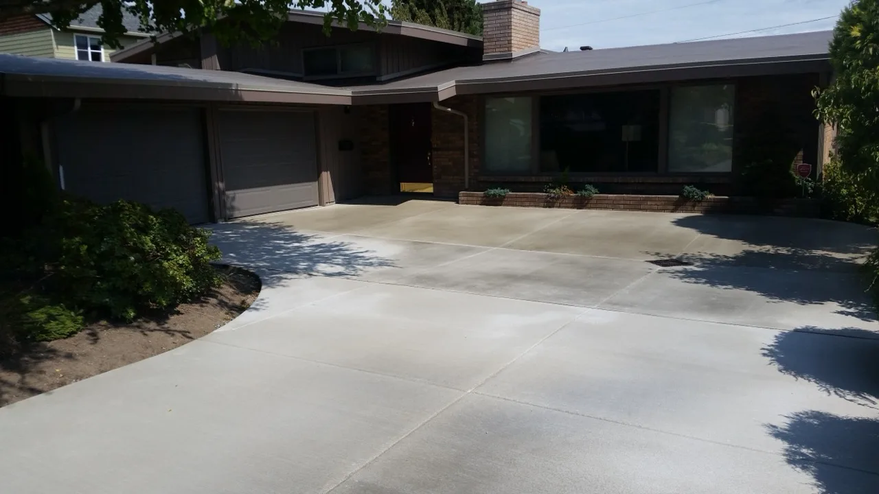Broom-finished concrete driveway in front of a single-family home