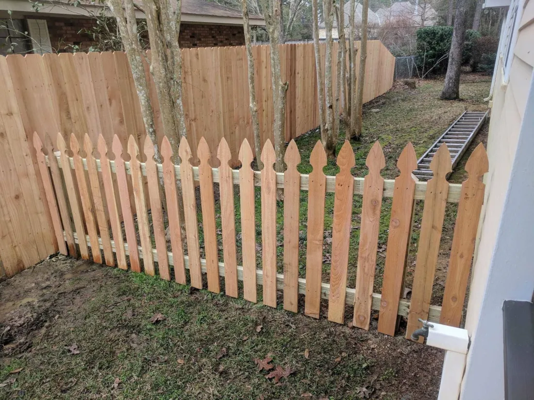 Wood picket fence installed along a property line
